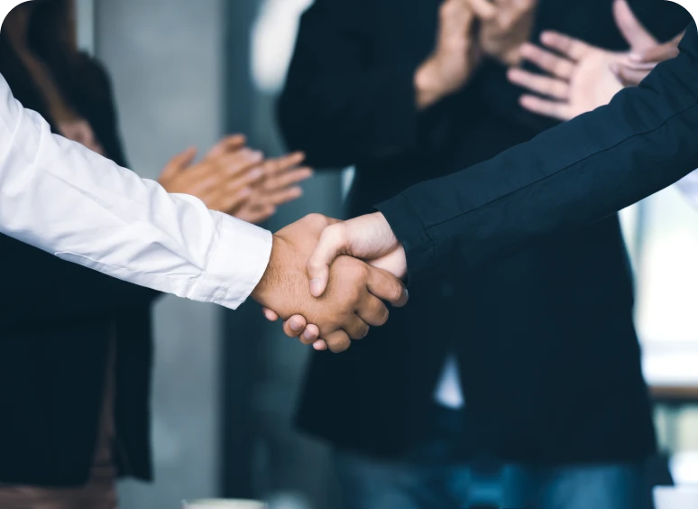 Business handshake with people clapping