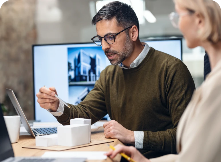 Architect presenting design plans on laptop